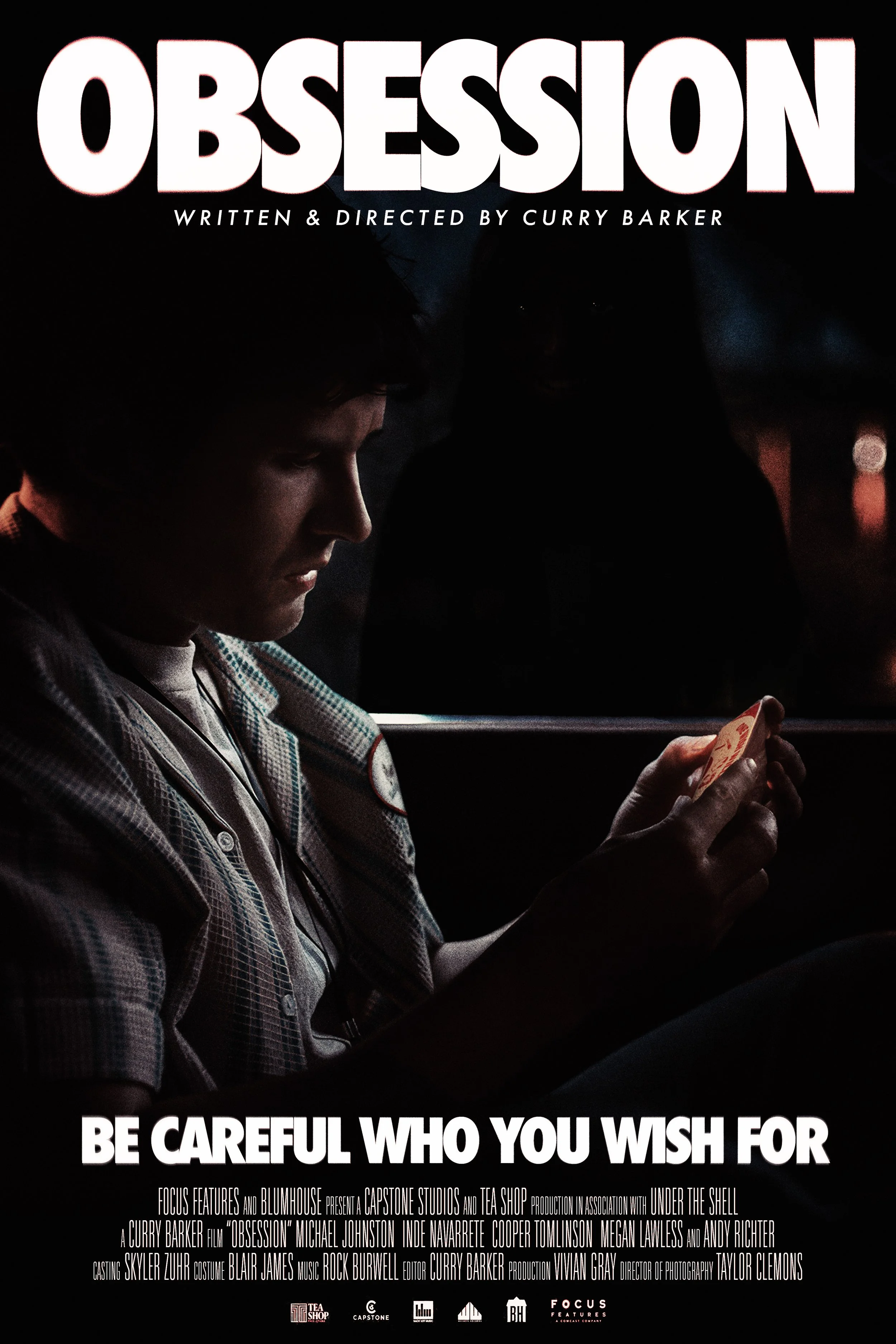 Movie poster for 'Obsession' written and directed by Curry Barker, featuring a young man in a plaid shirt looking at a phone with a dark background and text overlay.