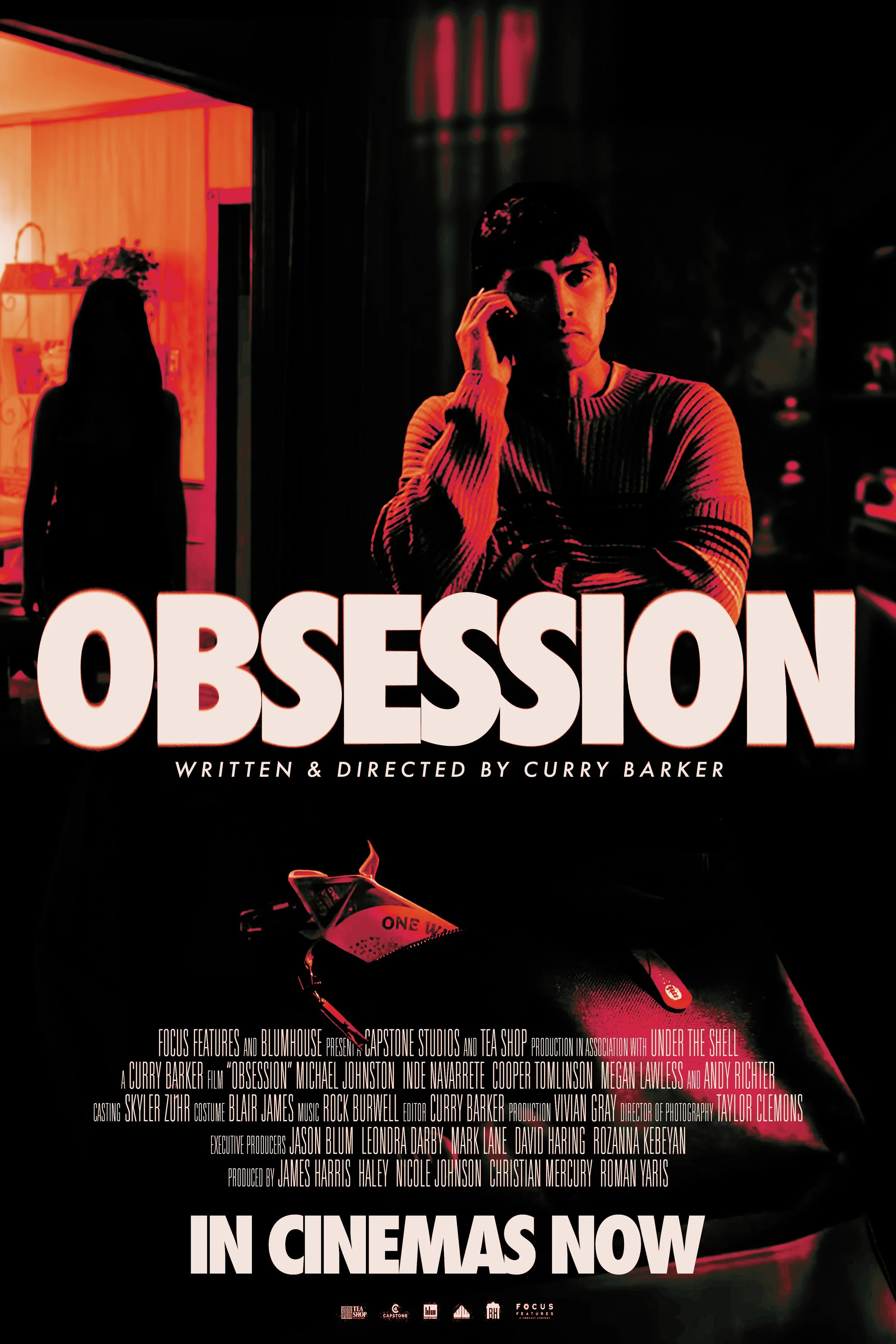 Poster for the film "Obsession" with a young man on the right talking on a cell phone, and a silhouette of a woman in the background, with text indicating it is now in cinemas.