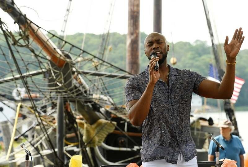  Quoron Walker sings 'Lift Every Voice and Sing,' with the replica schooner Amistad in the background, during the Juneteenth celebration Saturday, June 19, 2021, at Mystic Seaport Museum.&nbsp;&nbsp; (Dana Jensen/The Day) 