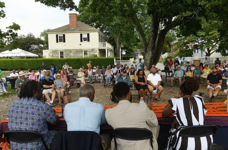  People listen to the panel discussion What is Juneteenth and Today's Implication with, from right, Panelist Karen Francis-Barnes, Ph.D. candidate at Stamford Schools; moderator Troy Brown, Amistad Freedom Institute chair; panelist Bob King, founding