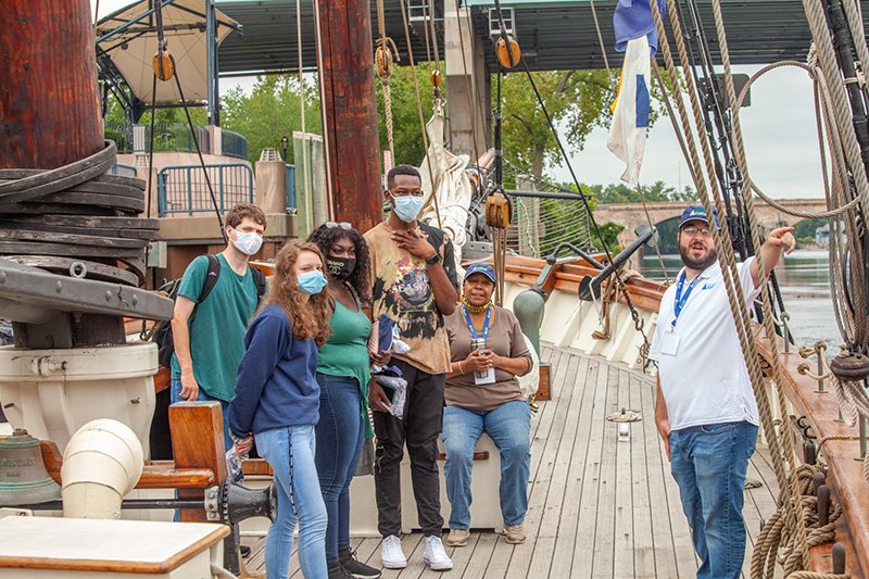 Discovering Amistad trainer Chris Menapace presents to Eastern students on the replica ship. 