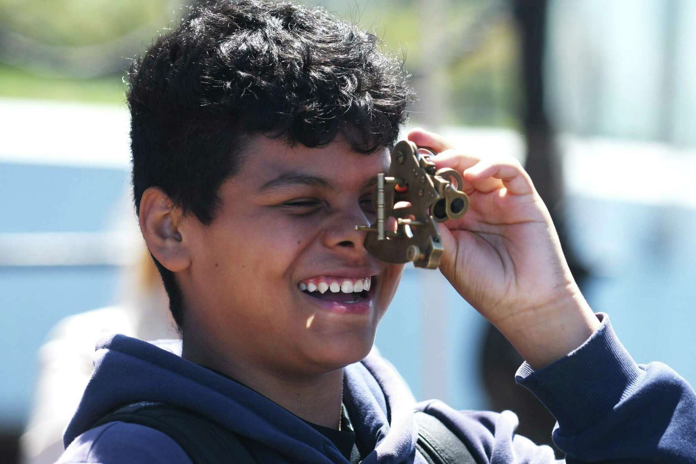  Eighth-grader Eduardo Quintana uses a sextant to determine geographical position while aboard a reproduction of the Amistad slave ship docked at Harbor Point in Stamford, Conn. Monday, May 9, 2022. Eighth grade students toured the ship to kick off t