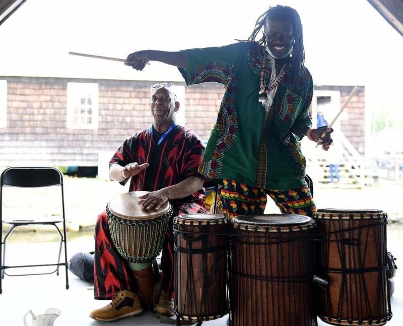  Inara Ramin, left, of Hartford, and Aly Tatchol Camara, originally of Guinea and now a New Haven resident, preform a Djembe drum call during a Juneteenth Celebration at the Mystic Seaport Museum on Sunday, June 19, 2022. The museum partnered with Di