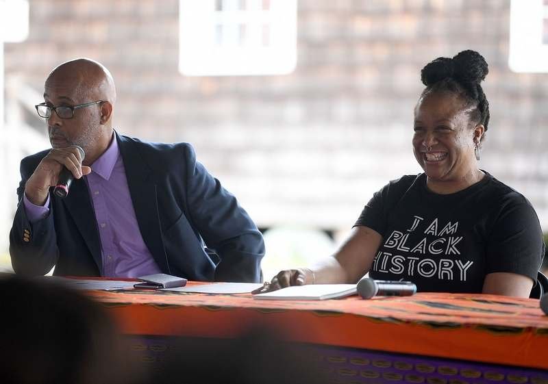  Panelist Dr. Lucinda Canty laughs during moderator Trevor Johnson´s introductions during a Juneteenth Celebration at the Mystic Seaport Museum on Sunday, June 19, 2022. The museum partnered with Discovering Amistad for the third year to celebrate th
