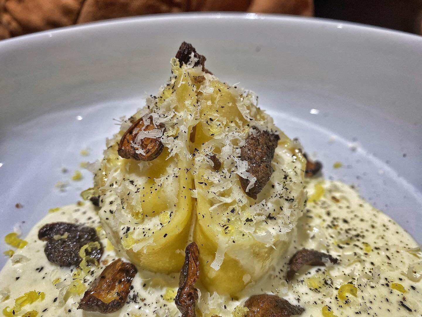 Late Summer Corn and Ricotta Triangoli.
.
Fresh egg dough filled with Iowa sweet corn, house made ricotta, and shaved white truffle. Finished with a thin truffled cream, crispy oven roasted Shiitakes, cured egg yolk, leek ash, shaved truffle pecorino