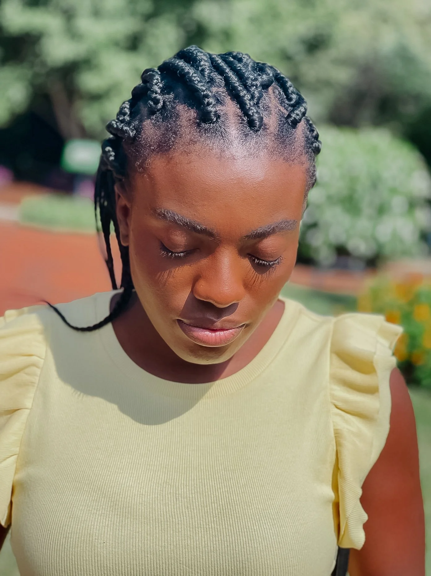 woman looking down with braids