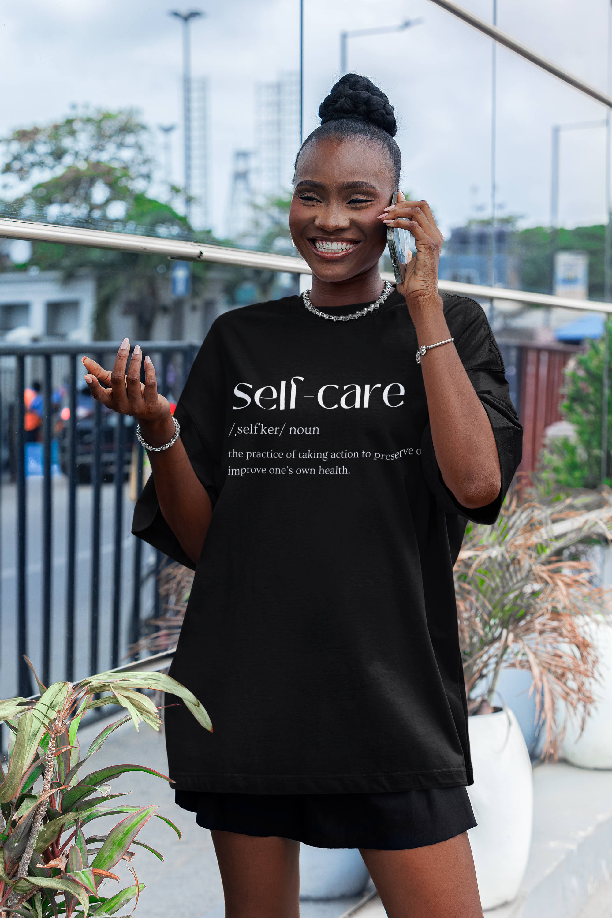 oversized-t-shirt-mockup-featuring-a-cheerful-woman-talking-on-the-phone-in-the-street-m55877-2.png