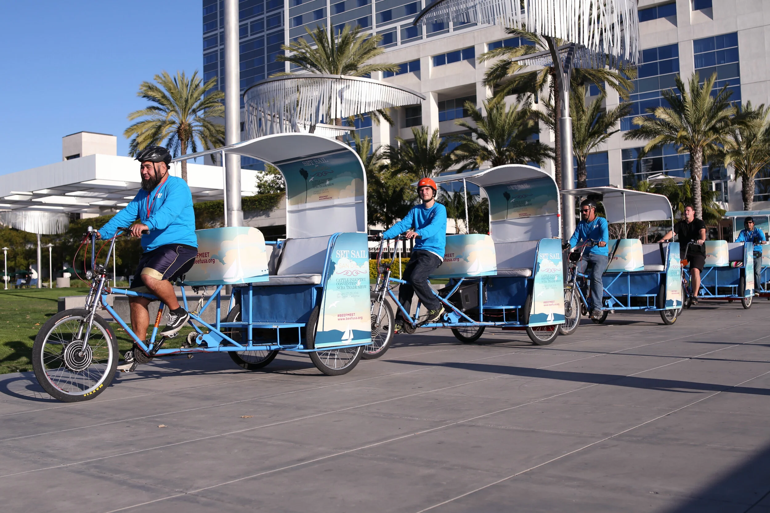 Pedicabs riding through downtown San Diego