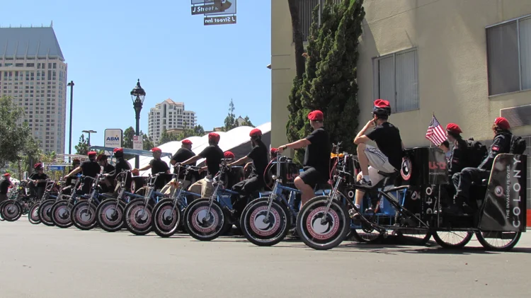 Pedicab drivers in matching uniforms