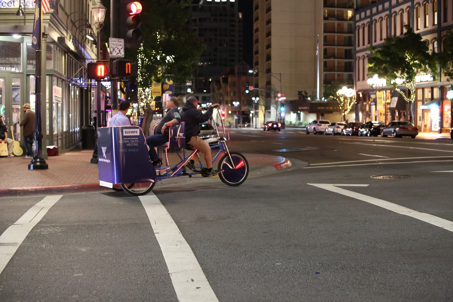Pedicab riding through downtown San Diego at night