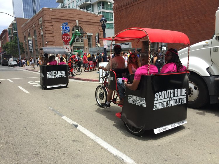 Pedicab with a branded red canopy
