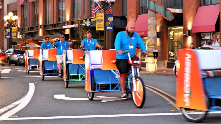 Branded pedicab on a downtown street