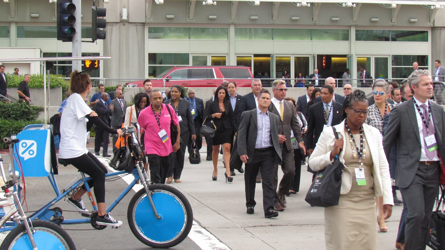 Convention attendees walking past a San Diego Pedicab