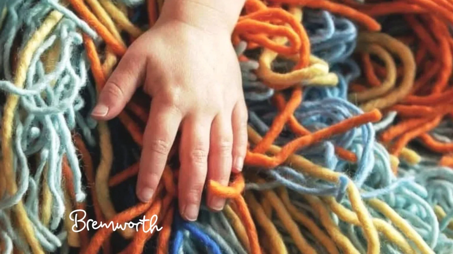 Child's_hand_in_yarn_202608061655.jpeg