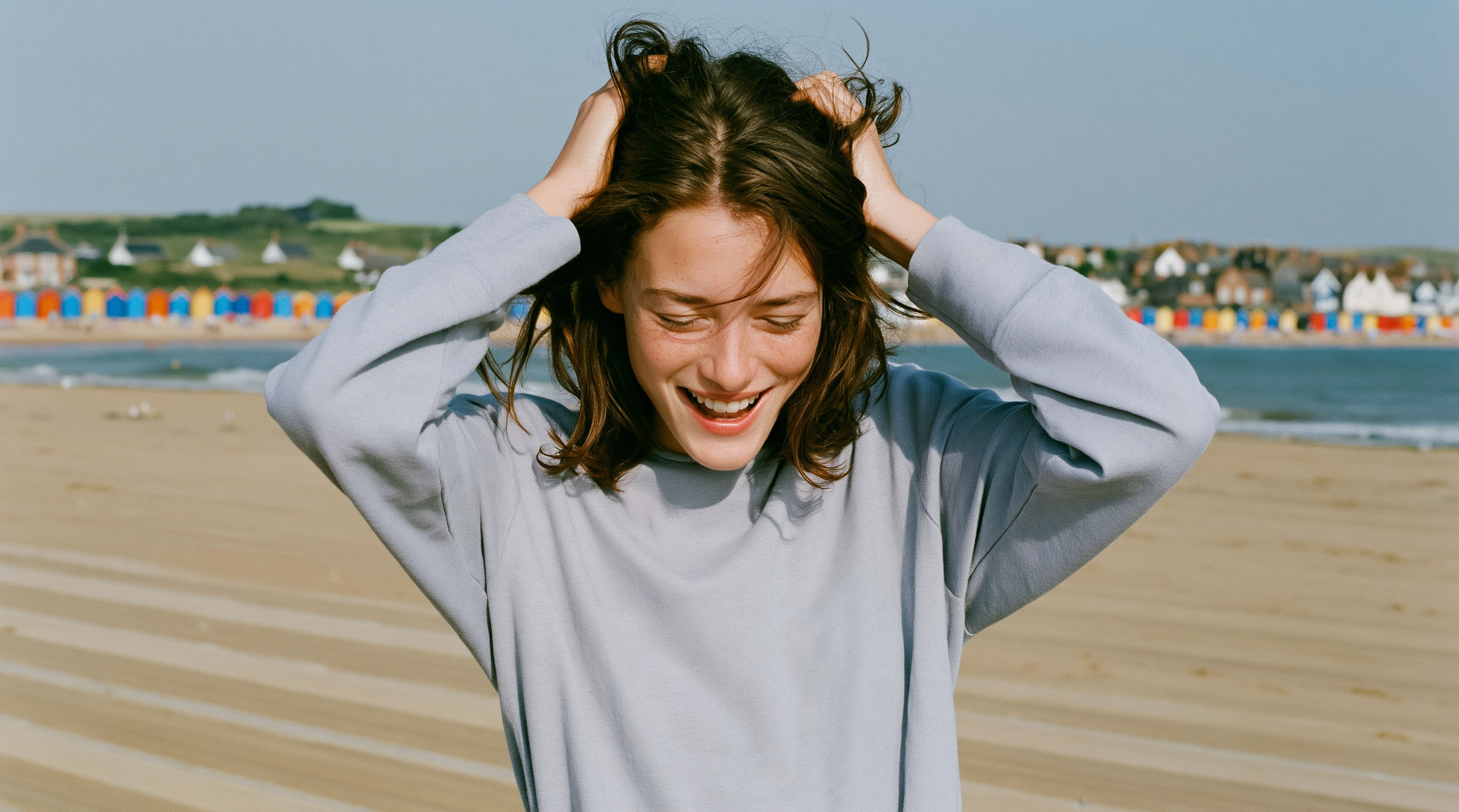 lucasmelb_a_medium_shot_of_a_woman_on_a_beach_smiling_with_he_36b6c611-0b70-4db7-bb2c-158b29c2bae0_1 (1).png
