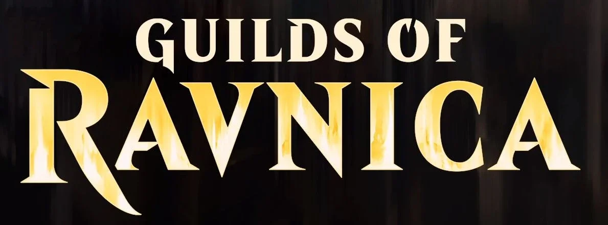 Sign with the text "Guilds of Ravnica" in large, bold, gold letters against a dark background.