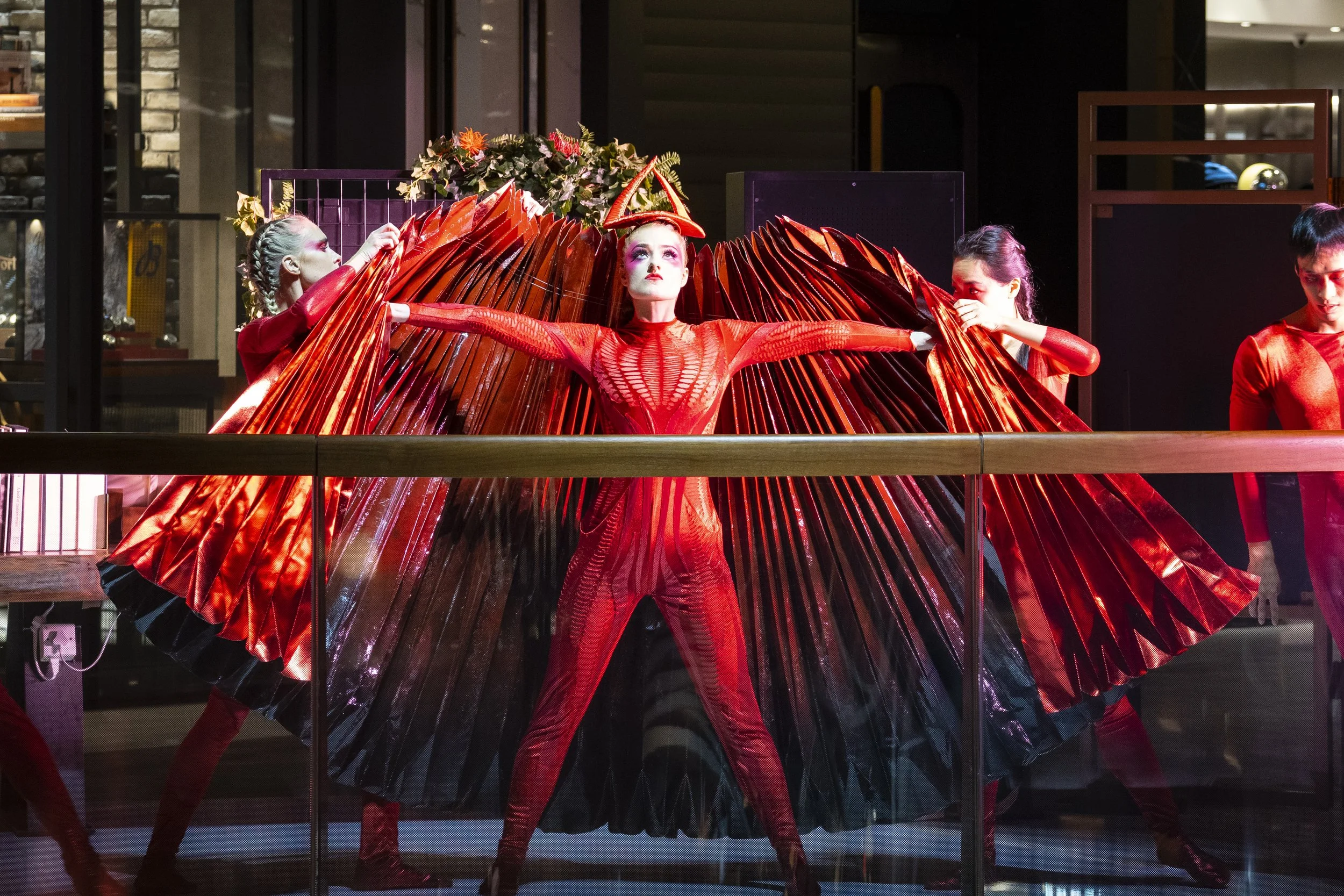 A performer from BPM Productions Hong Kong in a vibrant red winged costume at the 2019 K11 MUSEA grand opening, part of the "Silicon Valley of Culture" celebration.