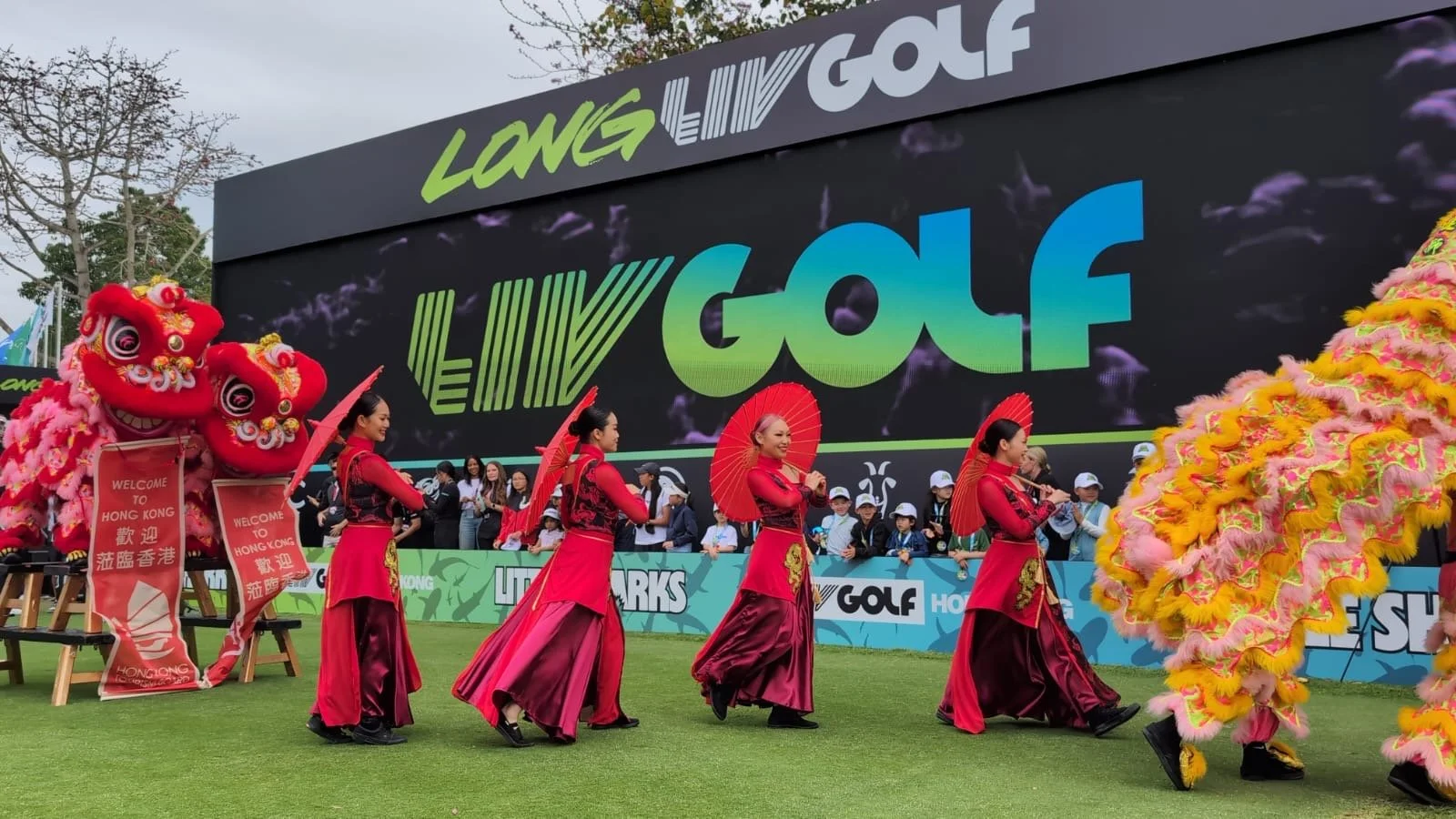 Dancers in red from BPM Productions Hong Kong alongside traditional lion dancers during the main entertainment program of the 2025 LIV Golf tournament.