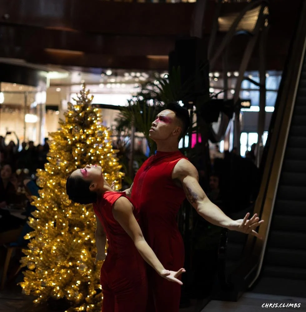 Contemporary dance performance at K11 MUSEA Hong Kong mall opening, featuring performers in red against a festive backdrop.