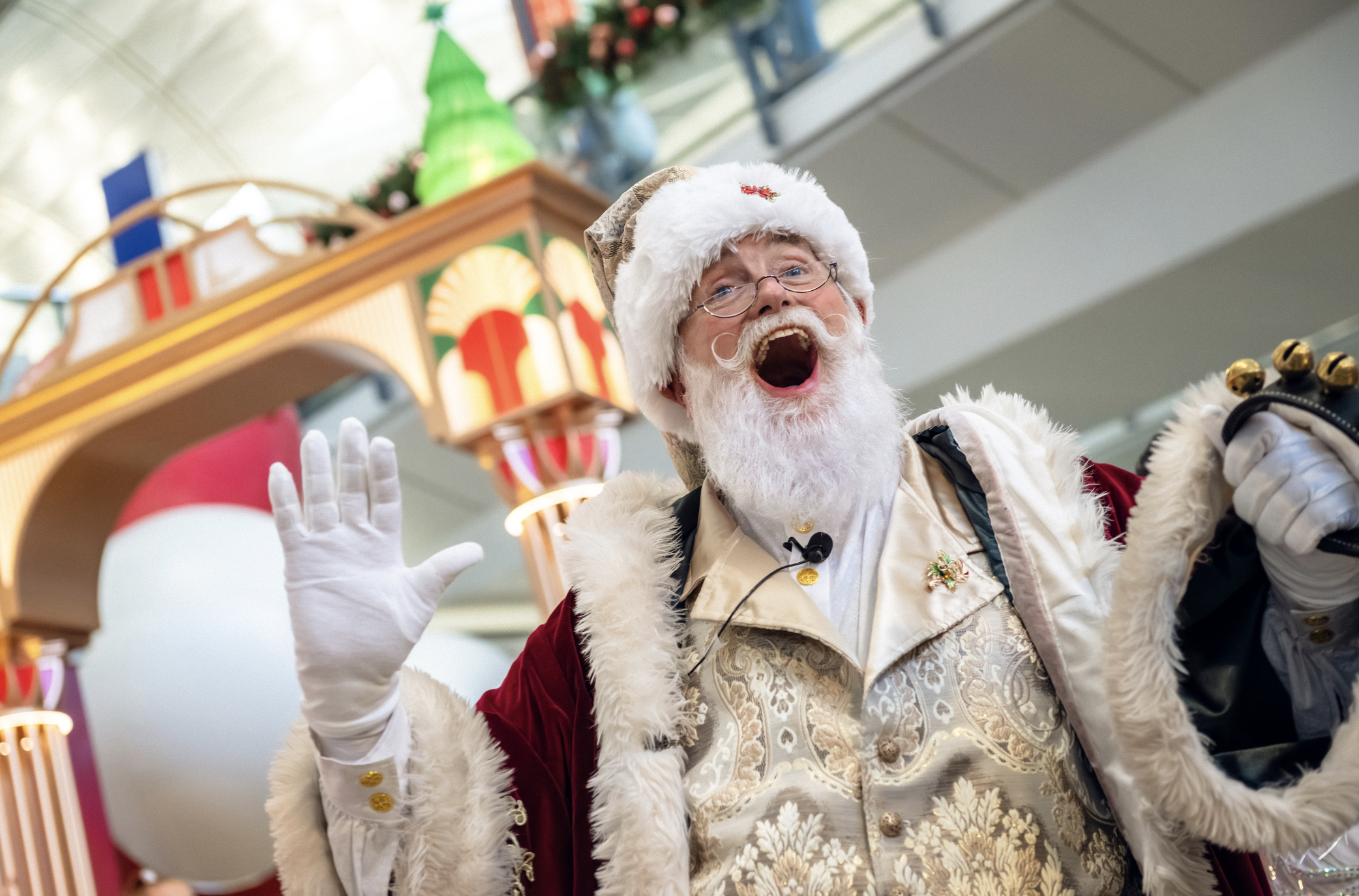 A joyful Santa Claus managed by BPM Productions Hong Kong greeting travelers during a festive Christmas appearance at Hong Kong International Airport.