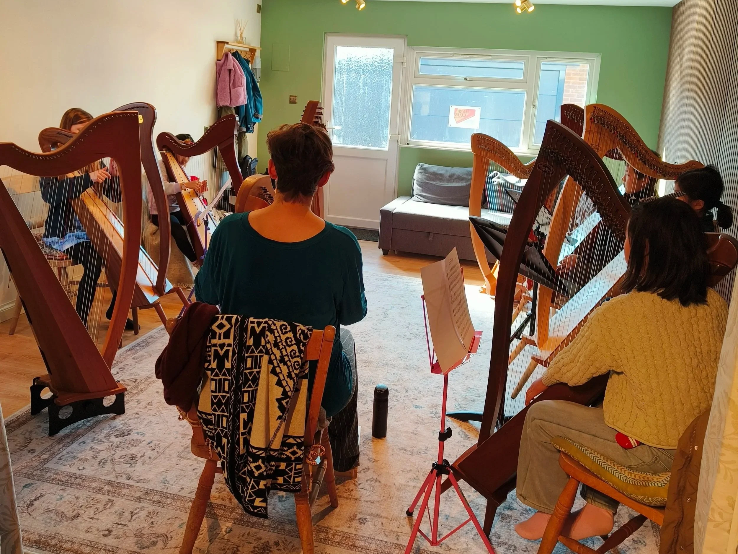 A group of harpists playing together as an ensemble.