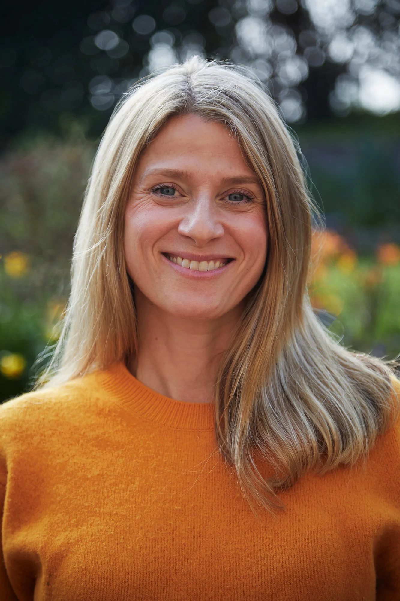 Photo of Lorna, standing outside in her garden in Chichester, UK
