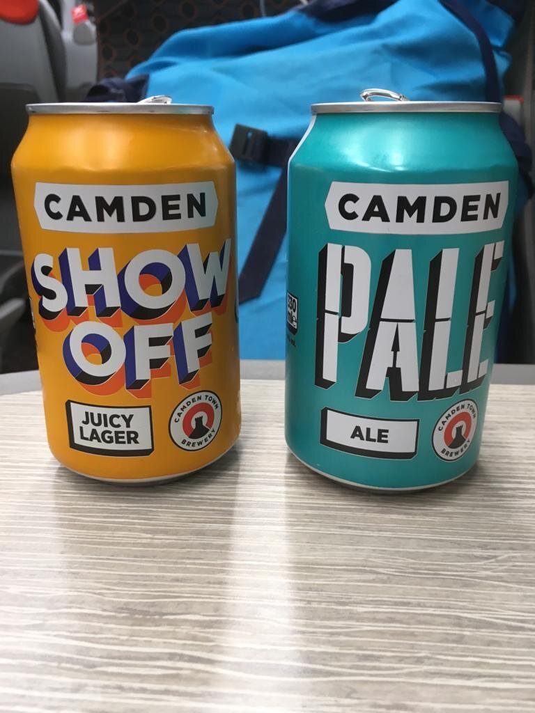Two cans of beer on the table on the train journey from London to York.