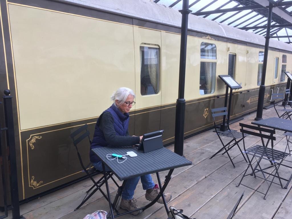 Byway traveller Catherine sitting at table at the National Railway Museum in York.