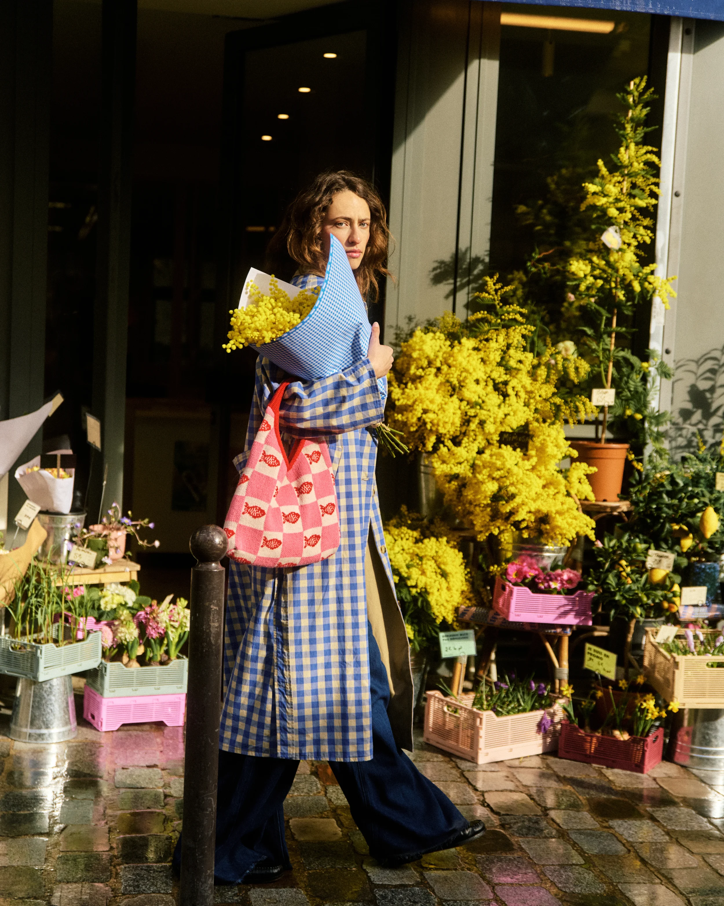 femme qui porte un sac et une veste sans manche en jean, elle pose devant la camera pour un shooting photo