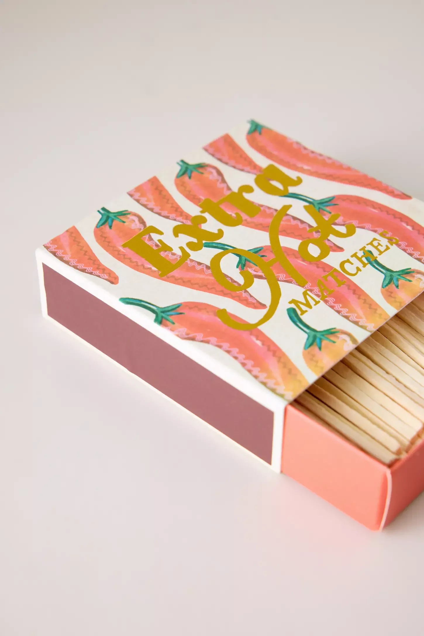 Détail de l'illustration piments et du lettrage doré Extra Hot.