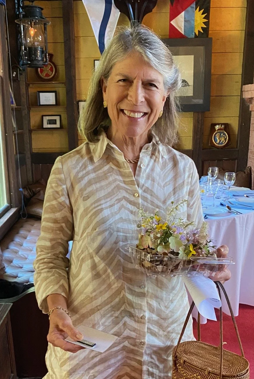 Freddy Shaw with flower arrangement for Annual Meeting