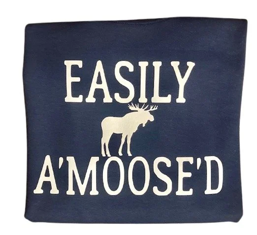 Explore the Easily A'moose'd T-Shirt featuring a cute moose graphic and funny pun. Perfect for nature lovers and casual wear enthusiasts.