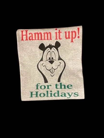 Celebrate the season with the Hamm’s Beer Bear "Hamm It Up for the Holidays" T-Shirt! This festive and nostalgic tee is perfect for beer lovers and holiday fun.