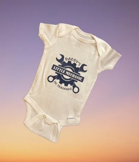 Custom baby bodysuit featuring “Daddy’s Little Mechanic in Training”