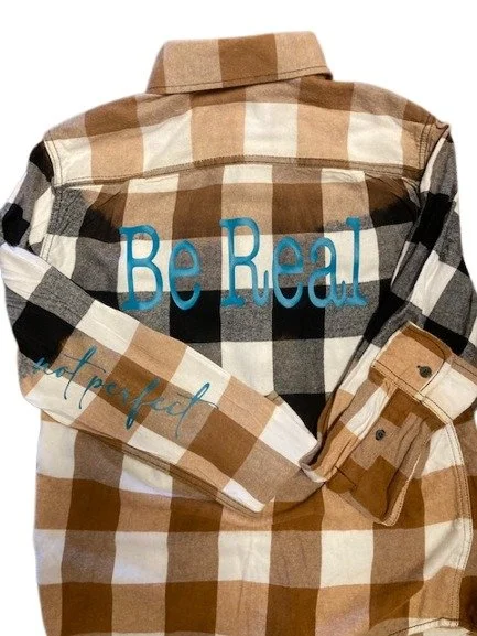 Distressed flannel shirt with motivational message Be Real