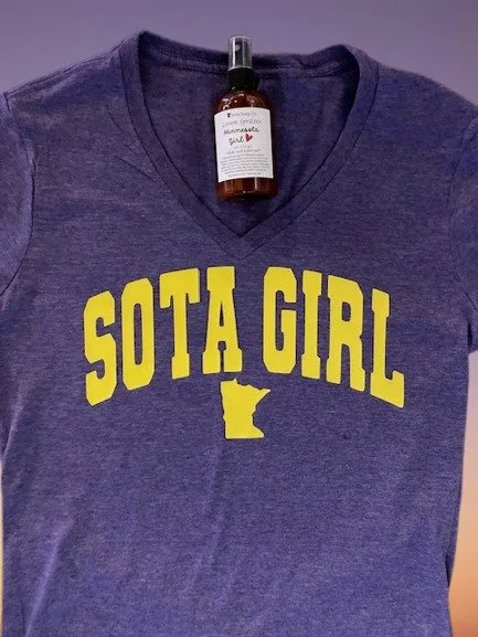 The "Sota Girl" Heather Purple Ladies Fitted V-Neck and Sota Soap Minnesota Girl Lotion Spritzer make the perfect Minnesota-inspired gift. Stylish, comfortable, and refreshing!