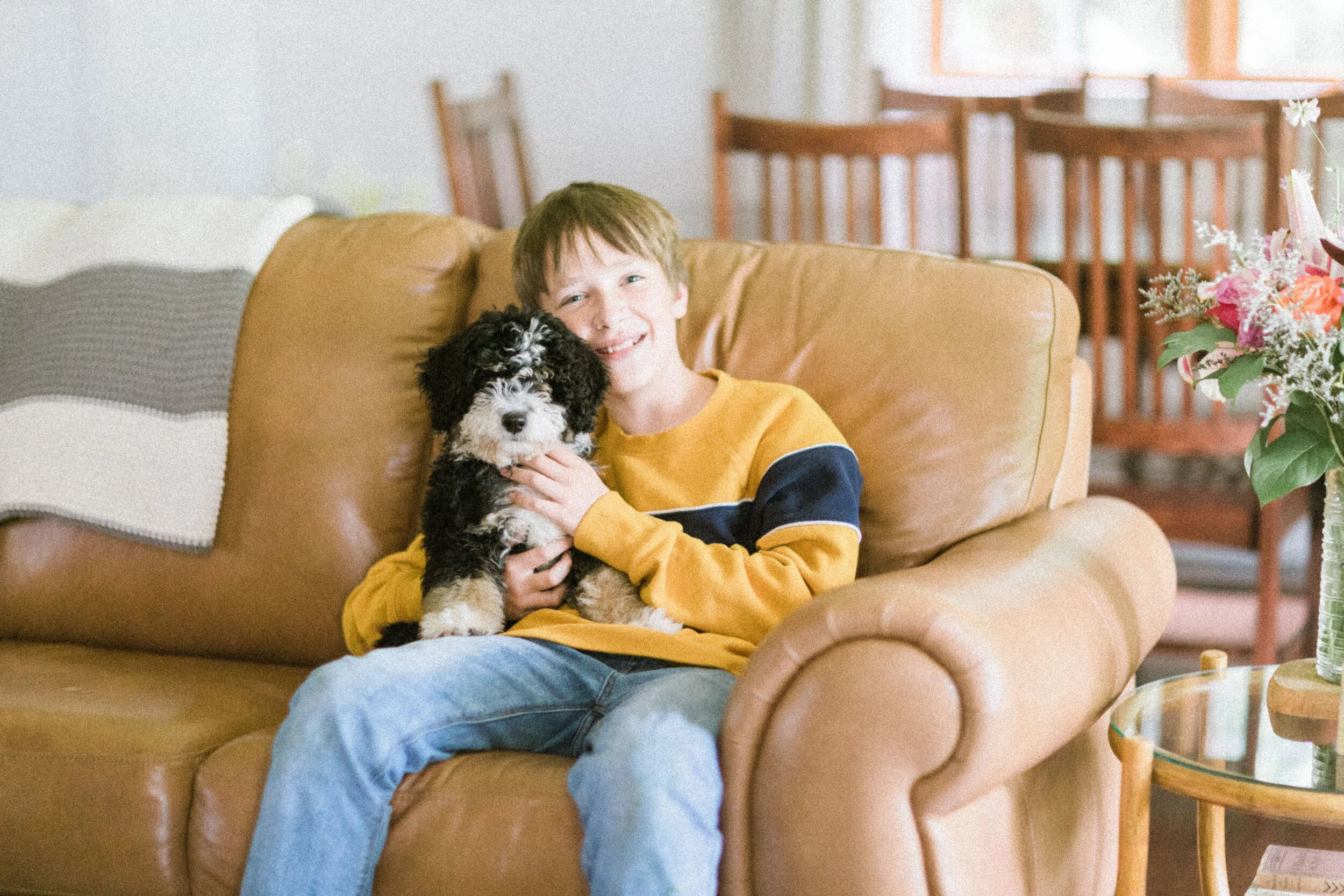 A Stokeshire family with their Munchkin Bernedoodle puppy.