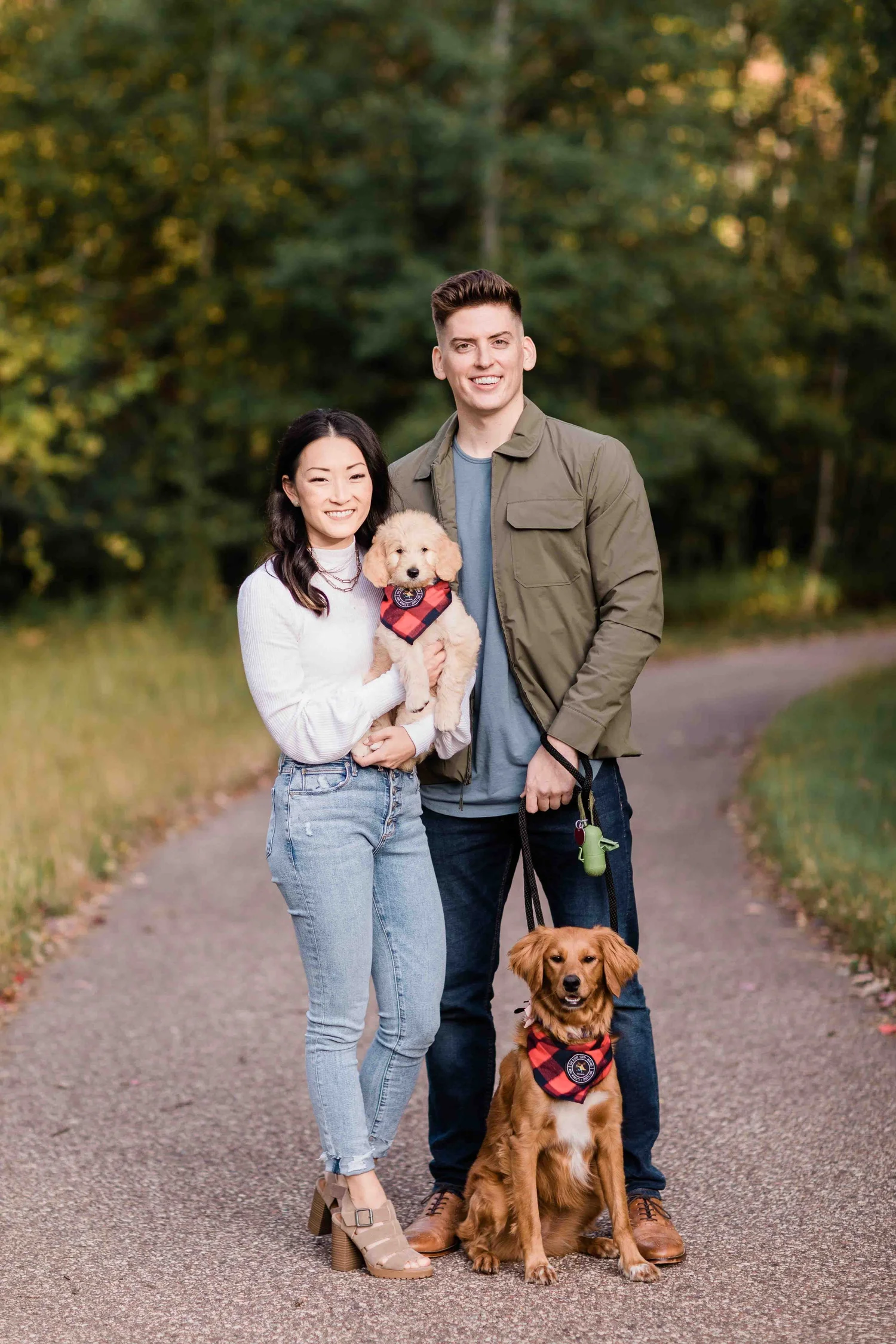 A family with an unfurnished, smooth-faced Goldendoodle puppy and a Golden Retriever, Stokeshire Designer Doodles, Wisconsin