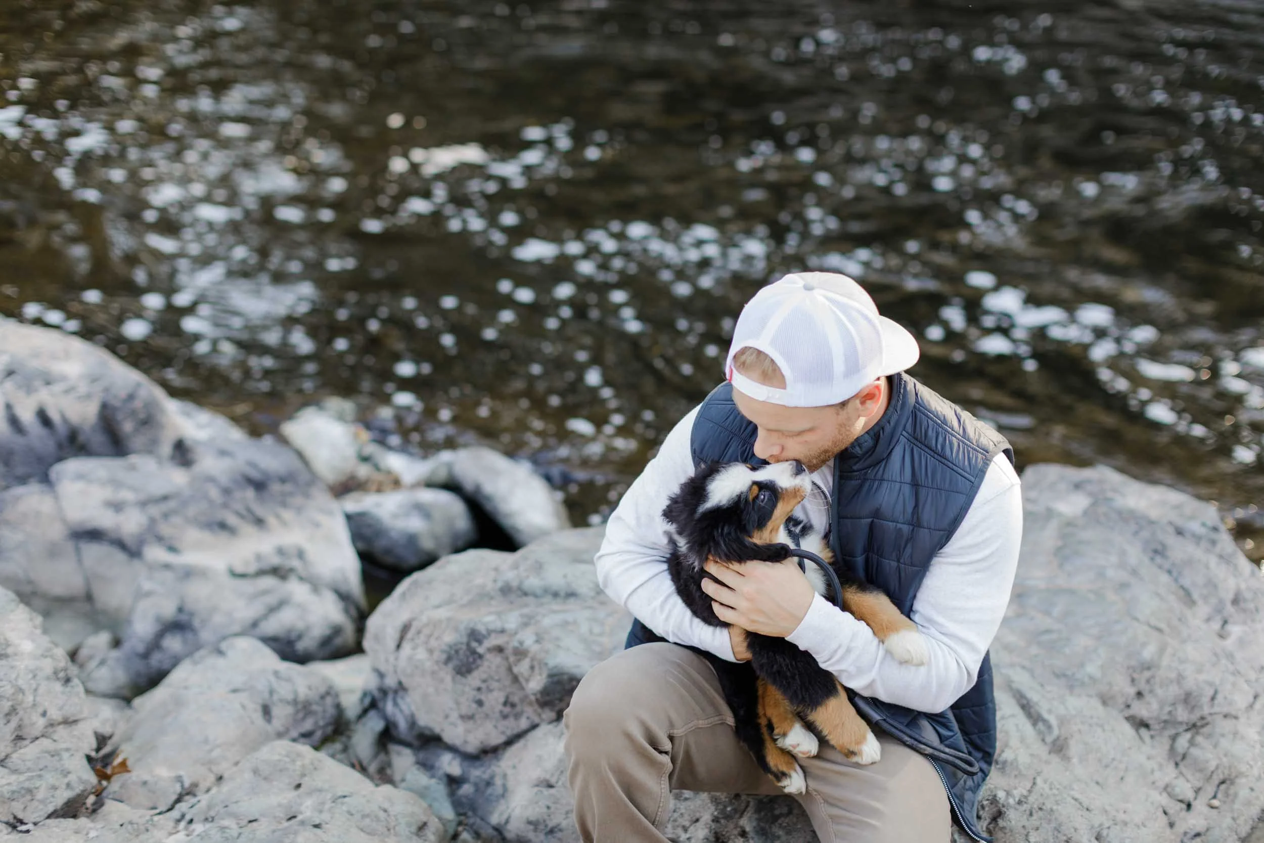 Ethical dog breeder holding a young dog outdoors