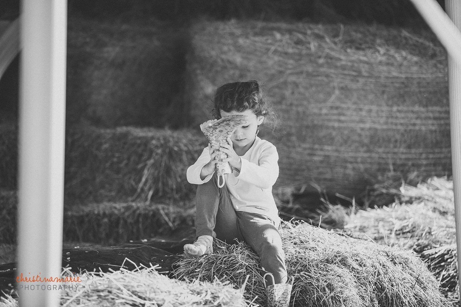 Child emptying hay from shoe