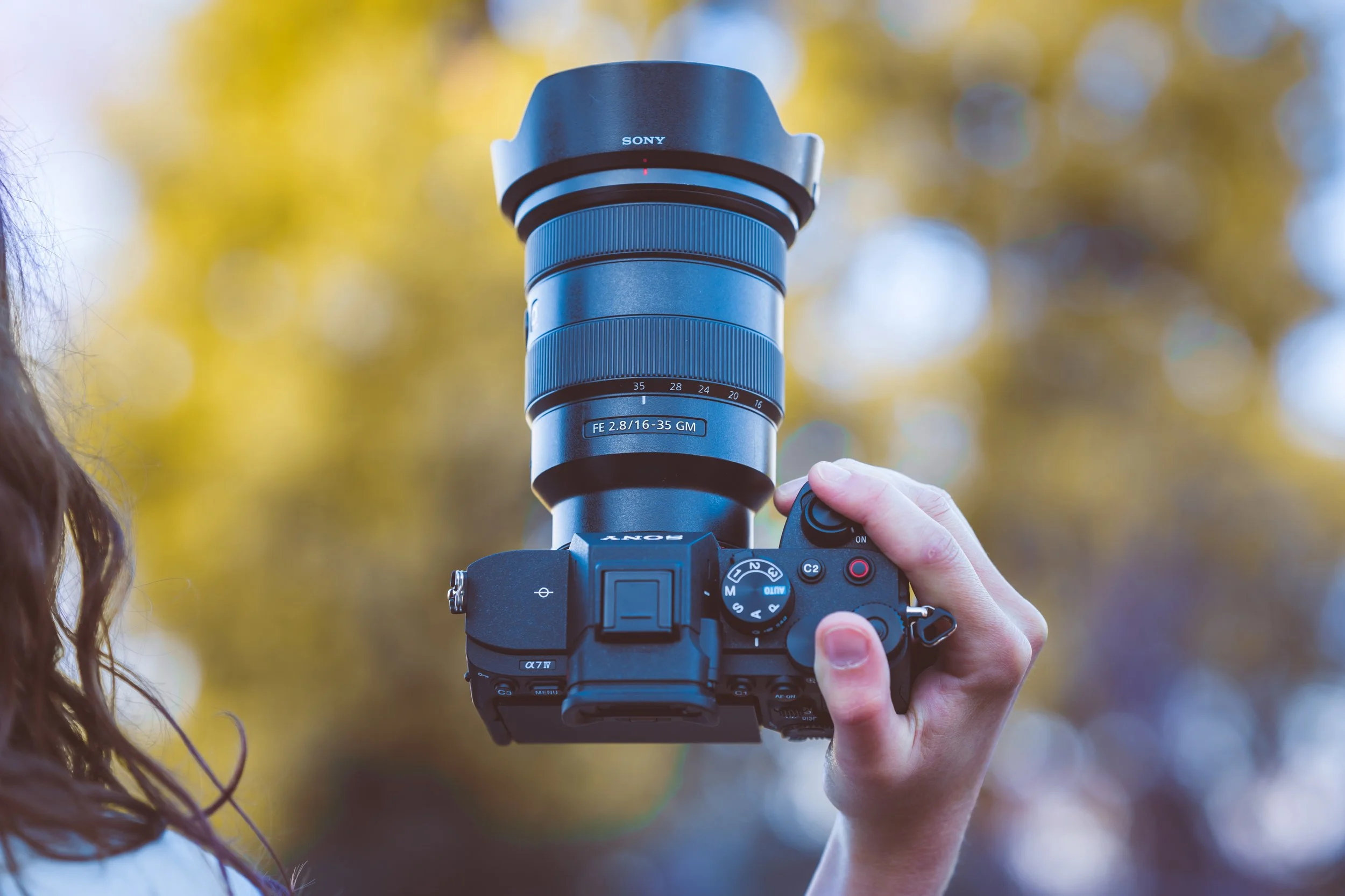 A professional photographer holds the Sony alpha 7 IV camera