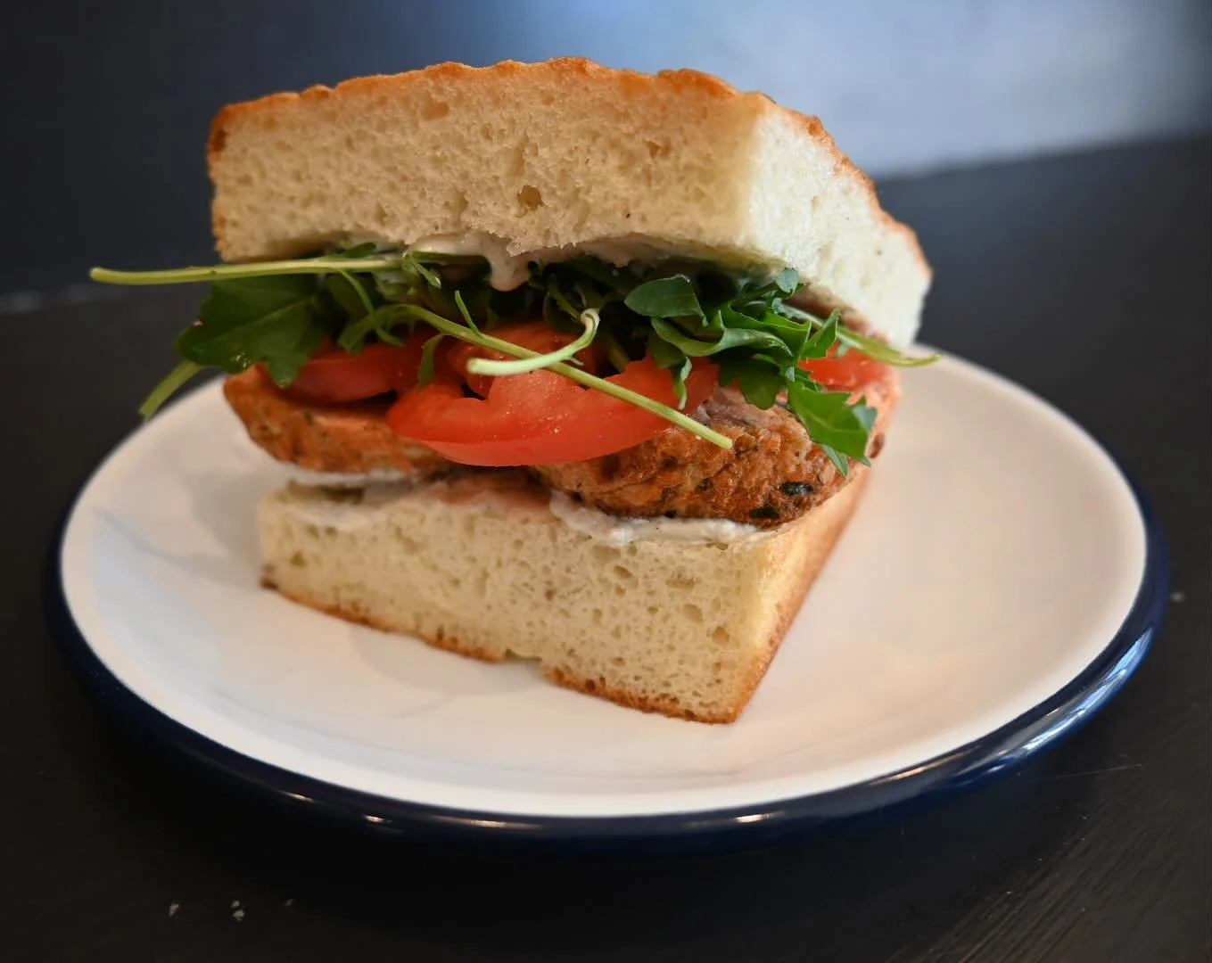 Today only, salmon cake sandwich on house made focaccia served with arugula, tomatoes and basil aoli.  Don&rsquo;t miss out.  We also have a few pieces of coconut cake with passion fruit curd and white chocolate frosting left! #langleykitchen