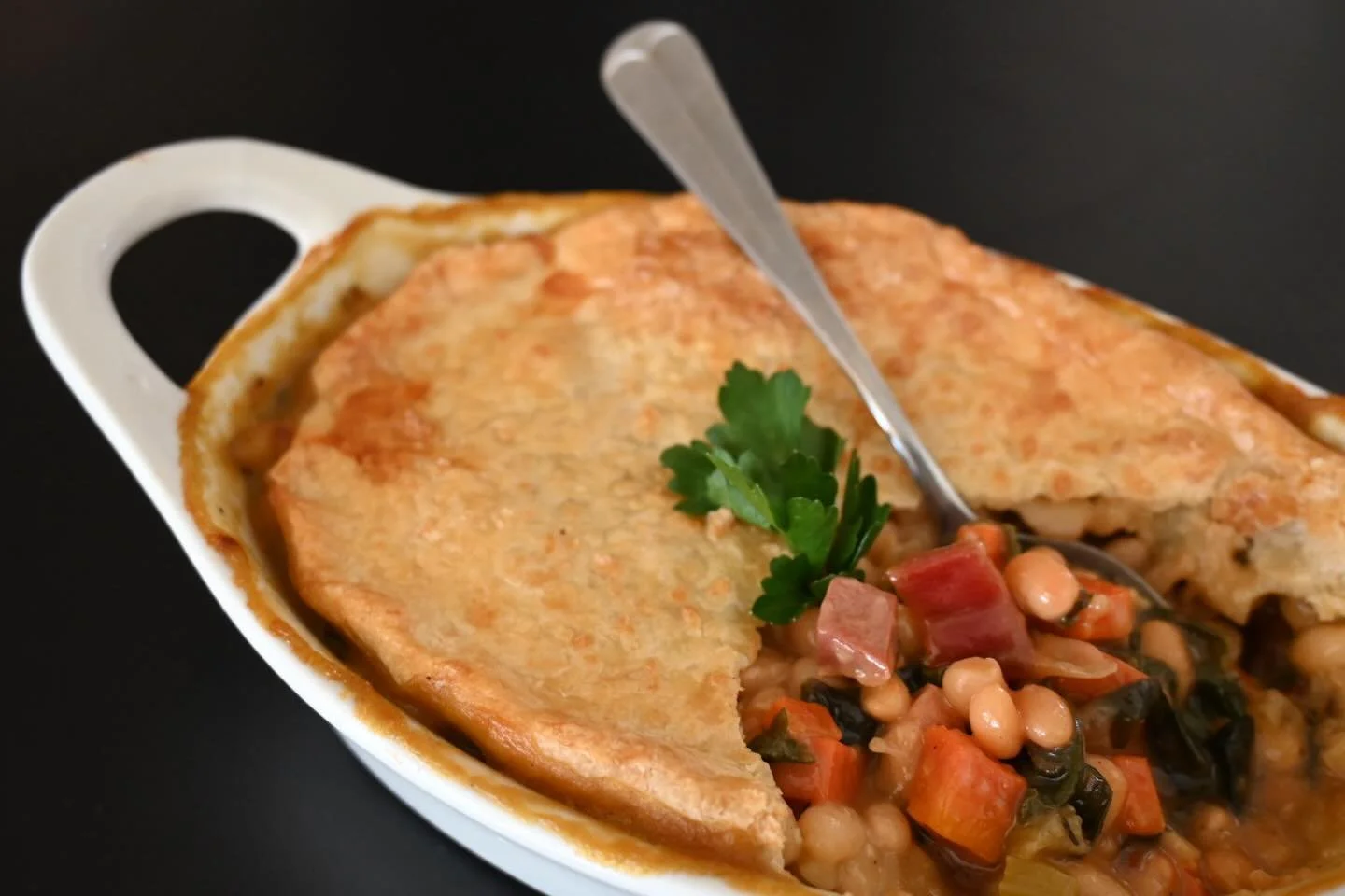 Thinking about what to have for dinner tonight? This week we have a wonderful new pot pie option in our grab and go refrigerator. Delicious and healthy, our White Bean, Pancetta and Chard Pot Pie is packed with creamy white beans cooked in our house 