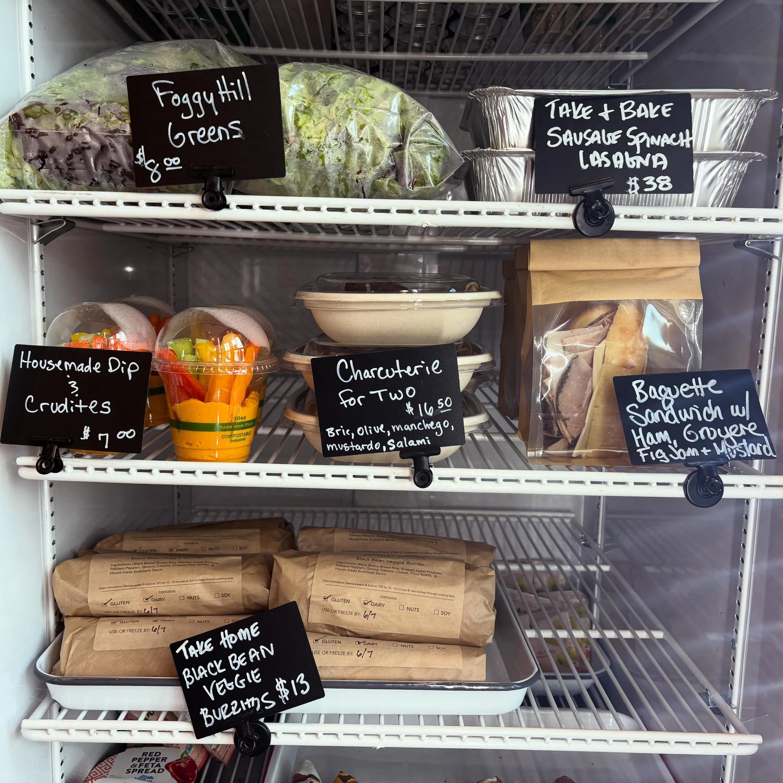 Come shop our grab and go fridge for an easy weekend lunch or picnic! Fully stocked with house made dip and crudit&eacute;, baguette sandwiches, charcuterie platters, and Take &amp; Bale dinner options, we&rsquo;ve got you covered whatever your day l