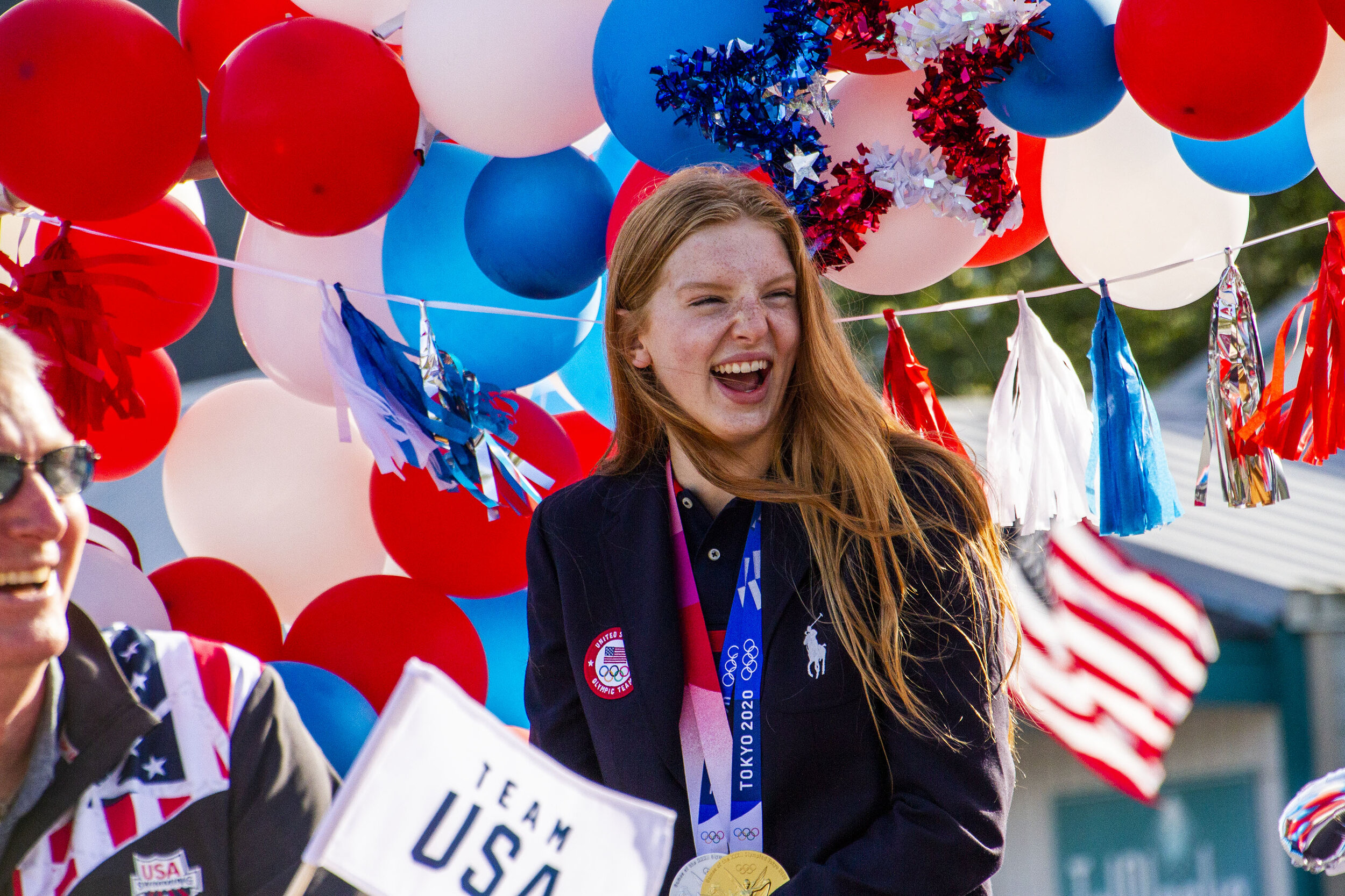 Jacoby laughs with locals screaming their congrats along the parade route on August 5, 2021 in Seward, Alaska.