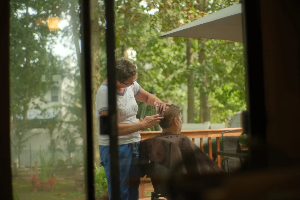  Our neighbor, Dee, comes over to cut my dad’s hair. In exchange for it, he gives her and her family a few dozen fresh eggs from the chickens he raises in our backyard. 
