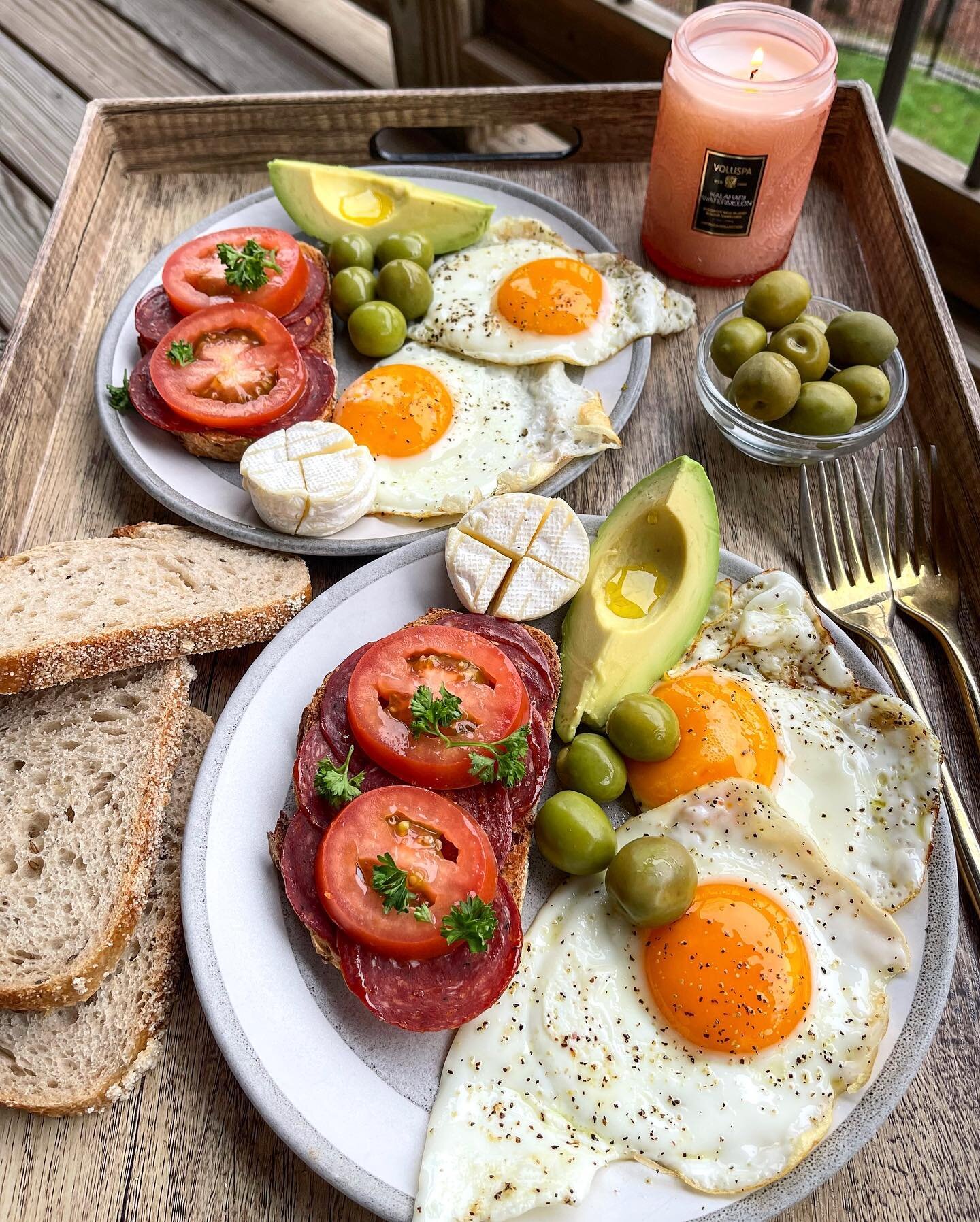 Rainy day romantic breakfast on the balcony 🤩🥰🔥 
Rye toast spread with butter, topped with salami, tomato, fresh parsley + s + p paired with fried eggs, olives &amp; brie 🧀 What did you have for breakfast? Share below 🥰
Happy Monday!🖤
.
.
.
.
.