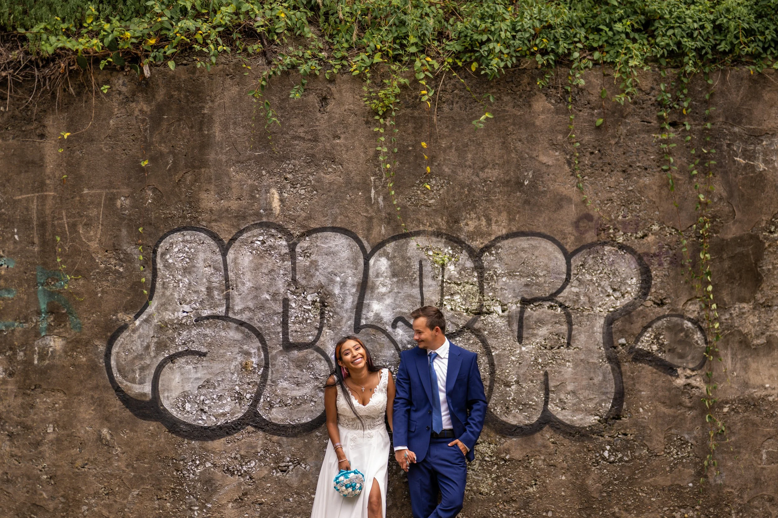 "New Jersey Wedding Photographer" a bride and groom pose in front of graffiti