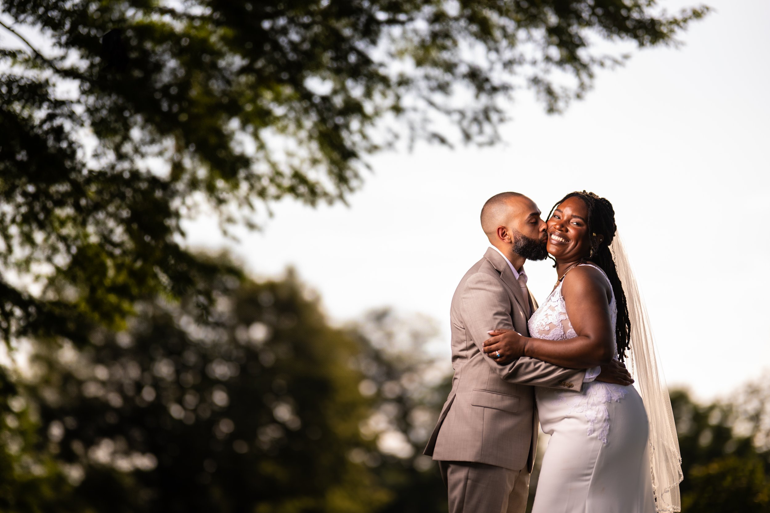 "New Jersey Wedding Photographer" a bride and groom pose in front of trees