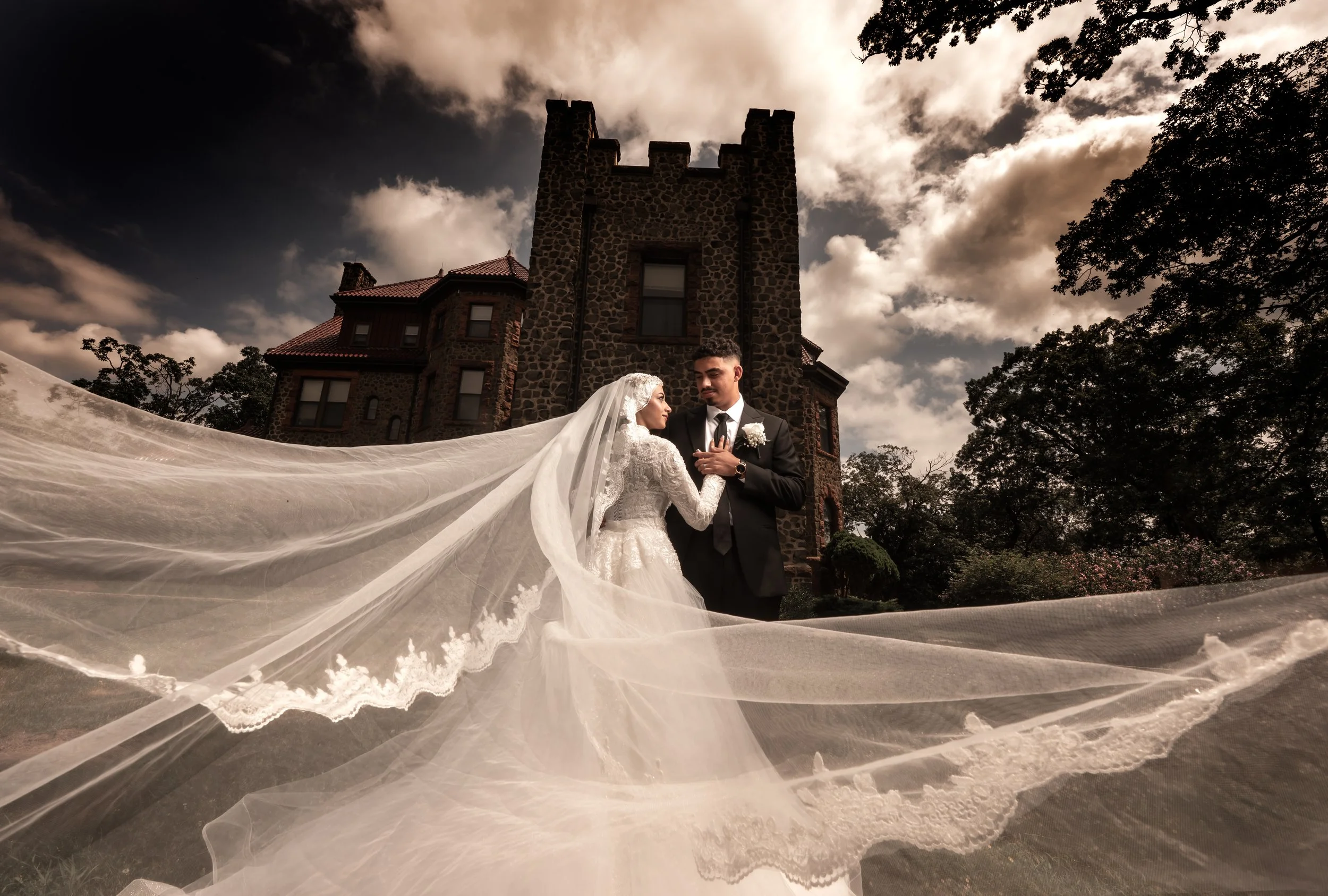 "New Jersey Wedding Photographer" a bride and groom pose in front of a castle